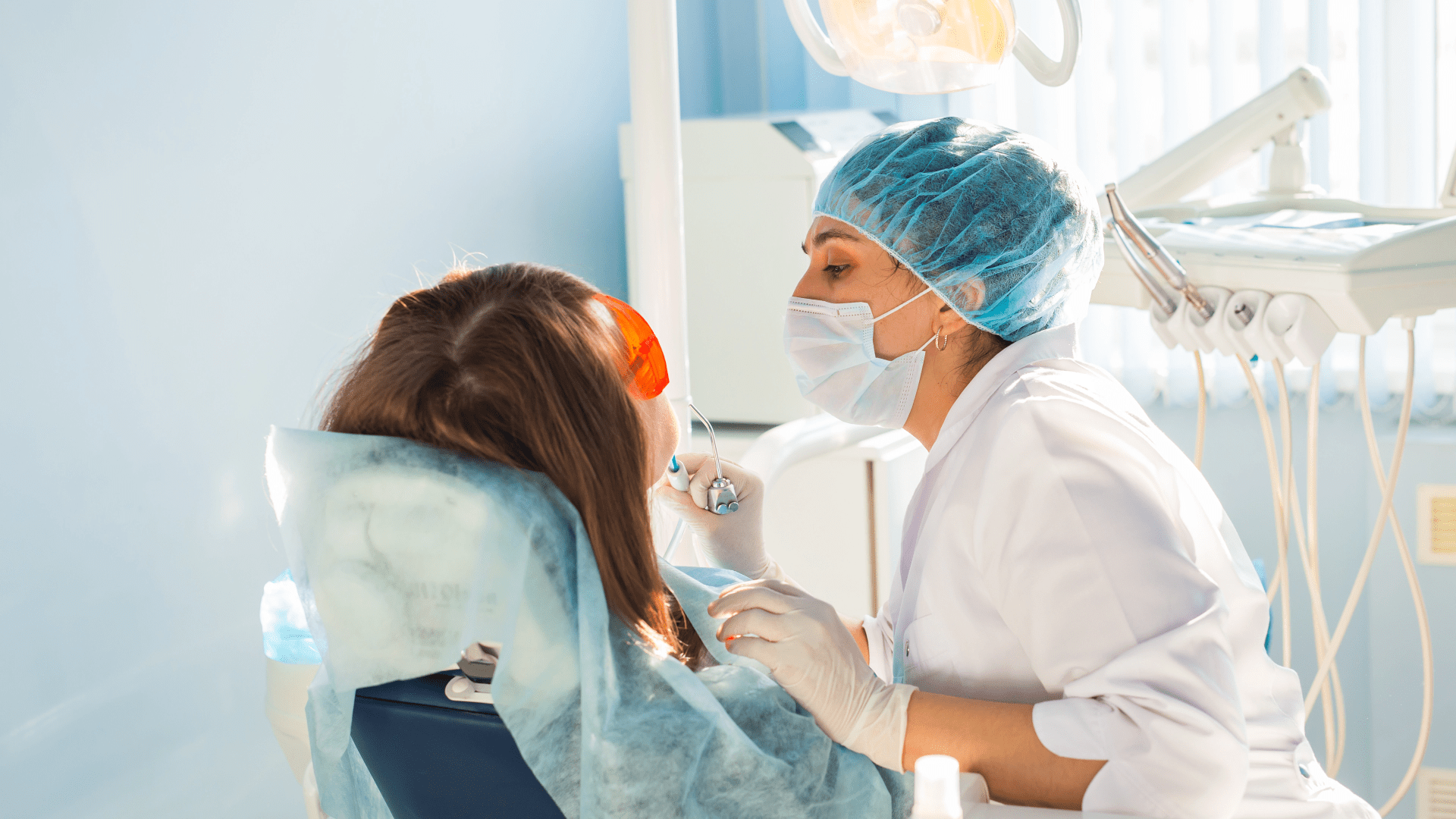 young-woman-getting-dental-treatment-dental-clini-2021-08-28-07-46-55-utc - Clínicas Doctores Romero